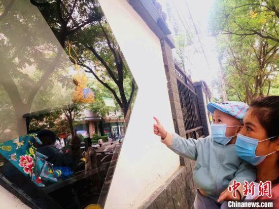 圖為蘭州市民在街頭觀賞刺繡和刻葫蘆的非遺展示。(資料圖) 史靜靜 攝